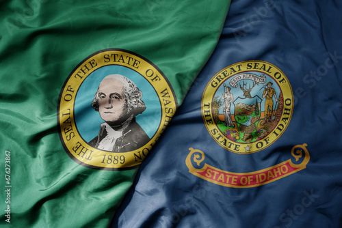 big waving colorful national flag of idaho state and flag of washington state . © luzitanija