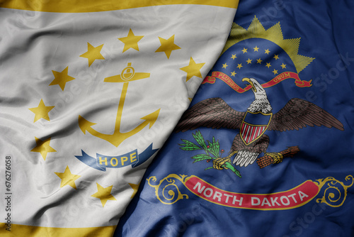 big waving colorful national flag of north dakota state and flag of rhode island state . photo