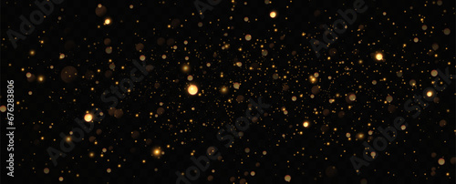 Golden sequins glow with many lights. Glittering dust. Luxurious background of golden particles.