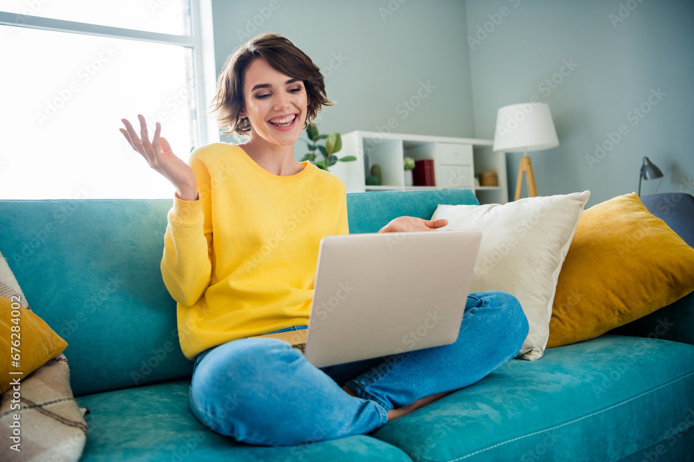 Photo of positive cheerful lady sitting couch using netbook have online lesson distant education indoors