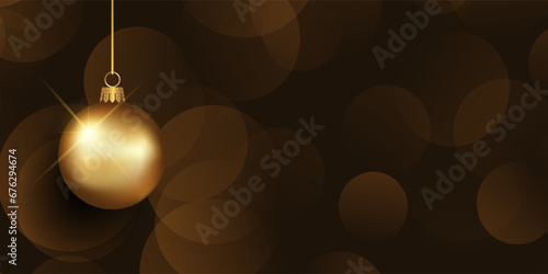 Christmas banner with hanging gold bauble on a bokeh lights background