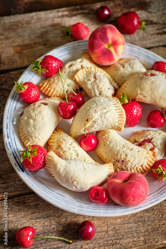 Mini cottage cheese pies with strawberries, cherries and peach.. Empanadas. Shortbread dough.