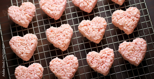 pink Heart shape crispie cookies for Valentine's Day on a cooling tray background. toning. selective focus photo