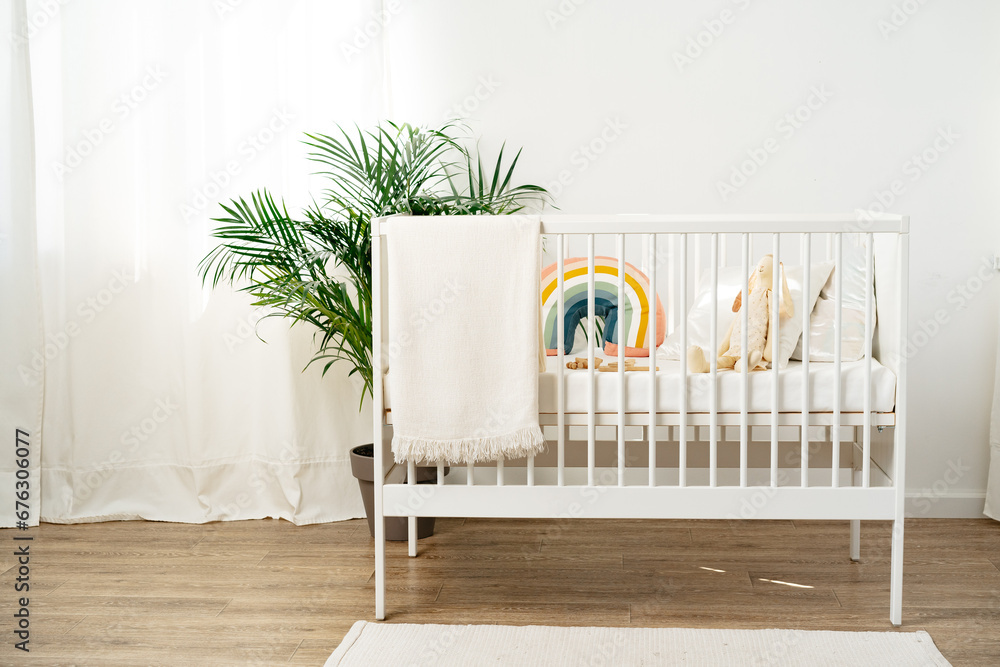 White wooden baby crib in nursery room - obrazy, fototapety, plakaty 