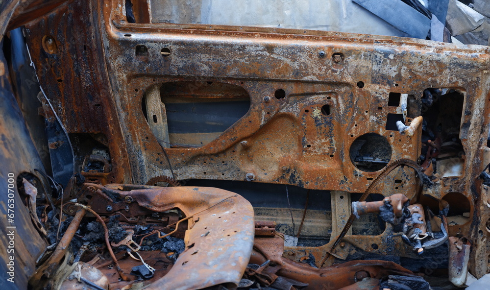 Burnt car after accident. Transport insurance. Old abandoned rusty car concept Burnt car after accident. Transport insurance. Old abandoned rusty car concept