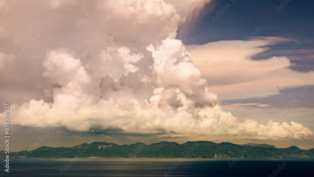 The formation of rain clouds above Lombok Island, Bali, Indonesia. Climate change, meteorology, global warming. Thick clouds floating over scenic green jungle-covered island in South East Asia. The formation of rain clouds above Lombok Island, Bali, Indonesia. Climate change, meteorology, global warming. Thick clouds floating over scenic green jungle-covered island in South East Asia.