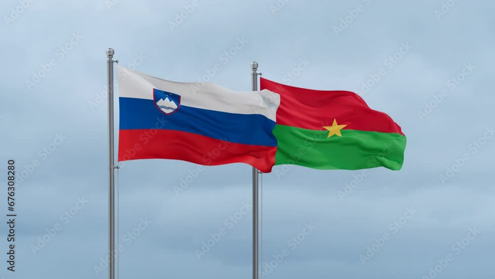 Burkina Faso flag and Slovenia flag waving together on cloudy sky, endless seamless loop, two country relations concept Burkina Faso flag and Slovenia flag waving together on cloudy sky, endless seamless loop, two country relations concept