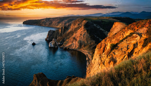 Dramatic coastal cliffs gleaming under a fiery sunset perspective shot from above