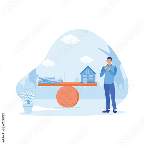 An adult man is standing beside a seesaw balancing between a stack of banknotes and a house model. Set against a backdrop of blurred urban buildings. House Model Balance Equilibrium concept.