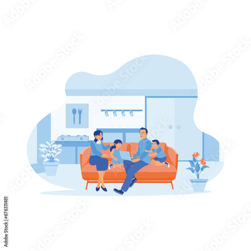 Happy family enjoying a weekend at home. They sat together on the sofa and had fun while playing on their laptop in the kitchen at home. A couple of happy, funny parents concepts. 