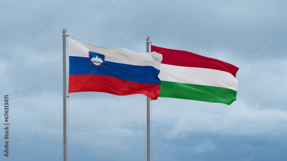 Hungary flag and Slovenia flag waving together on cloudy sky, endless seamless loop, two country relations concept Hungary flag and Slovenia flag waving together on cloudy sky, endless seamless loop, two country relations concept