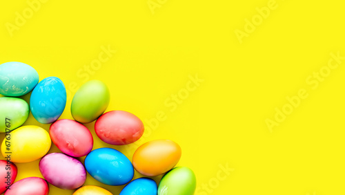 Vibrantly colored Easter eggs on a yellow background