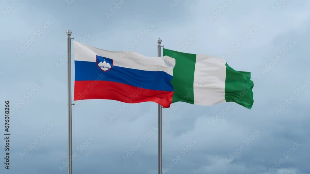 Nigeria flag and Slovenia flag waving together on cloudy sky, endless seamless loop, two country relations concept Nigeria flag and Slovenia flag waving together on cloudy sky, endless seamless loop, two country relations concept