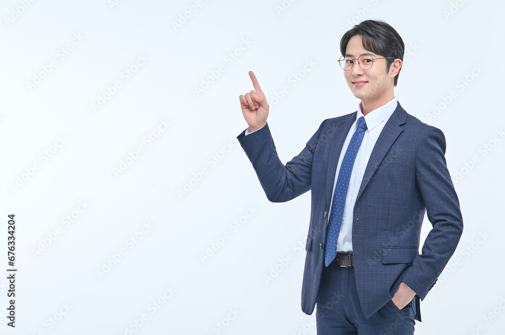 A young and handsome Asian man in a suit is wearing glasses and making various facial expressions and hand gestures. A young and handsome Asian man in a suit is wearing glasses and making various facial expressions and hand gestures.