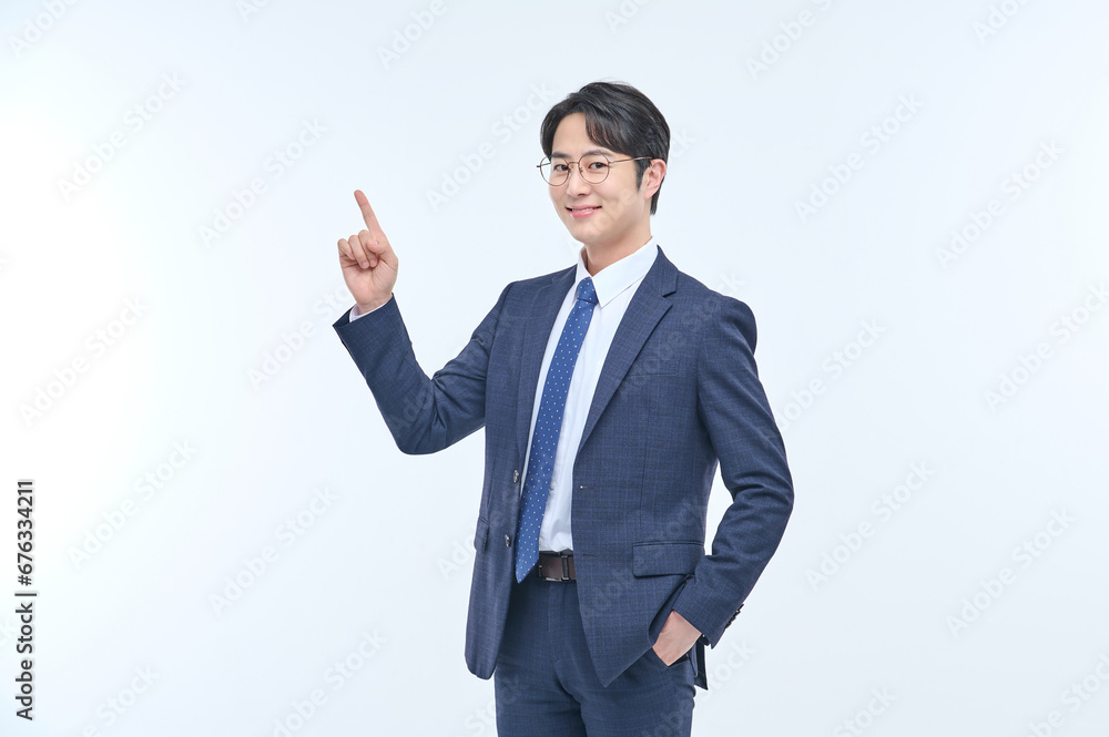 A young and handsome Asian man in a suit is wearing glasses and making various facial expressions and hand gestures. A young and handsome Asian man in a suit is wearing glasses and making various facial expressions and hand gestures.