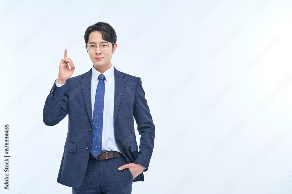 A young and handsome Asian man in a suit is wearing glasses and making various facial expressions and hand gestures. A young and handsome Asian man in a suit is wearing glasses and making various facial expressions and hand gestures.