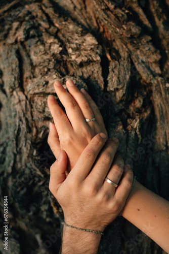 hands of a man and woman with rings on their wedding day