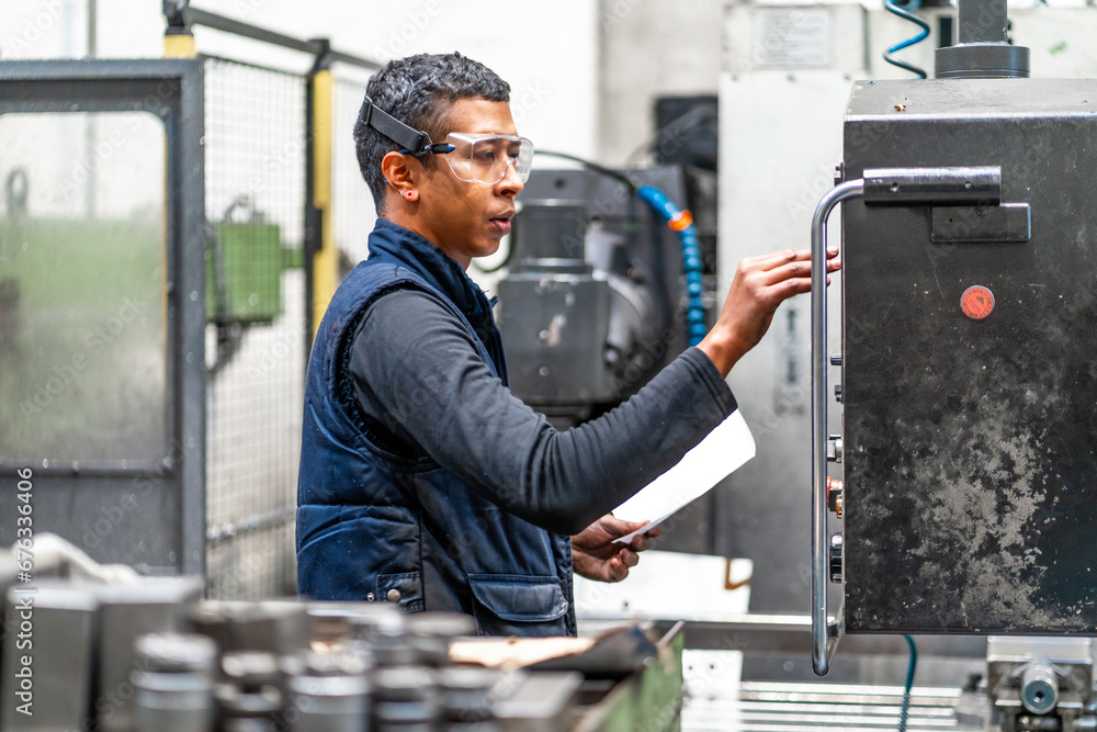 Latino worker operator in the metal industrial factory trade in the numerical control sector Latino worker operator in the metal industrial factory trade in the numerical control sector