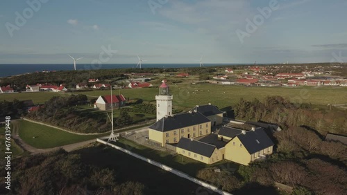 Hanstholm Fyr, Thisted, Denmark - Lush Foliage Envelops the Lighthouse - Drone Orbit photo