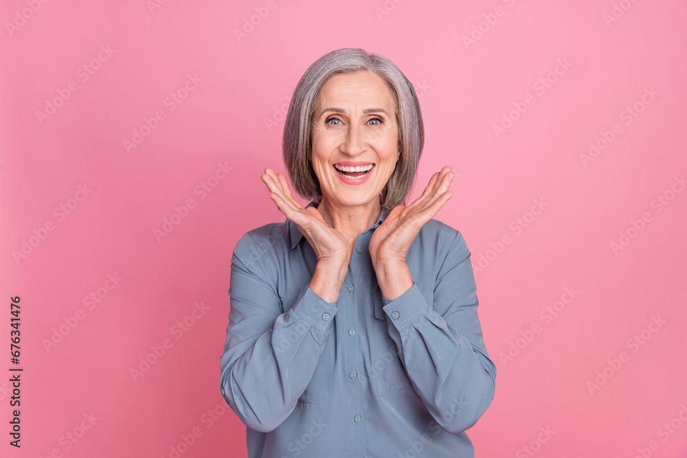 Portrait of satisfied cheerful person with gray short hair wear stylish shirt hold hands near face smiling isolated on pink background Portrait of satisfied cheerful person with gray short hair wear stylish shirt hold hands near face smiling isolated on pink background