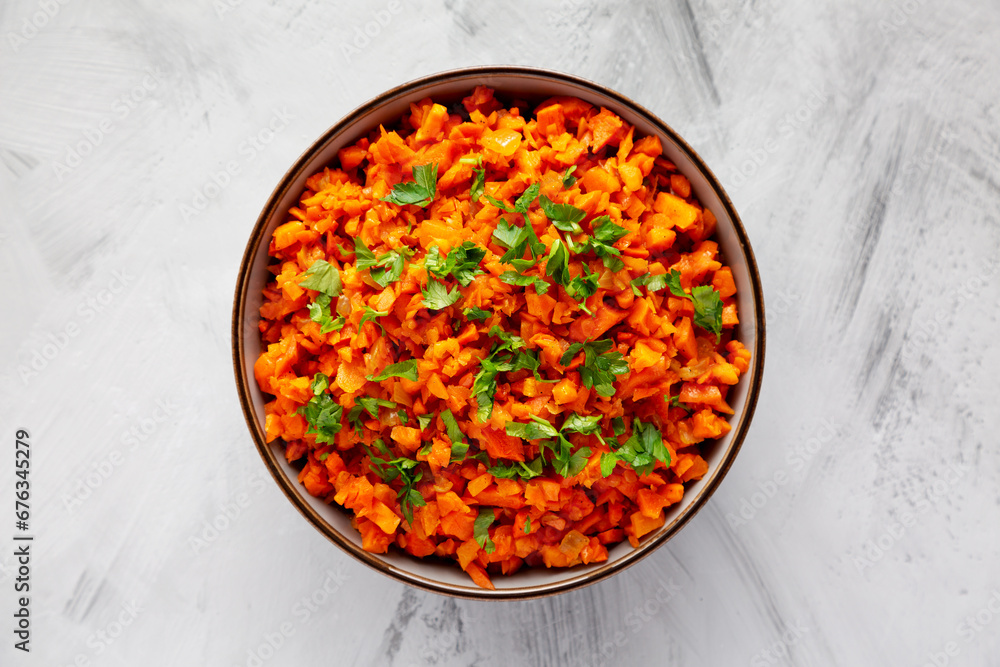 Homemade Smoky Spiced Carrot Rice with Parsley in a Bowl, top view. Flat lay, overhead, from above. Homemade Smoky Spiced Carrot Rice with Parsley in a Bowl, top view. Flat lay, overhead, from above.