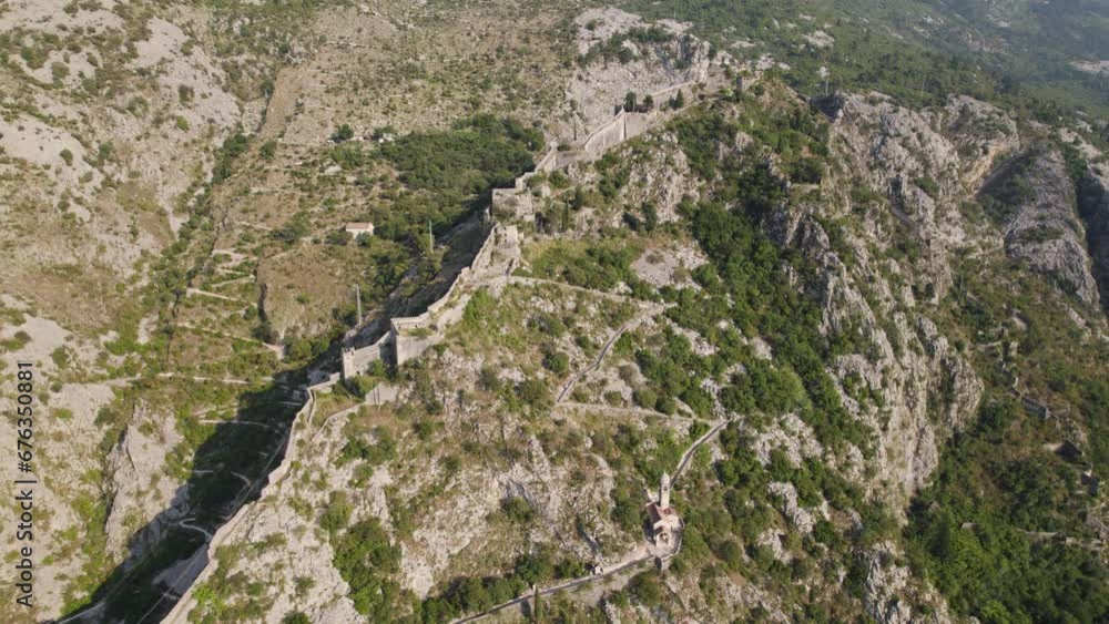 Hillside Walls of Kotor fortress in Montenegro, mountain fortifications of Kotor, aerial view Hillside Walls of Kotor fortress in Montenegro, mountain fortifications of Kotor, aerial view