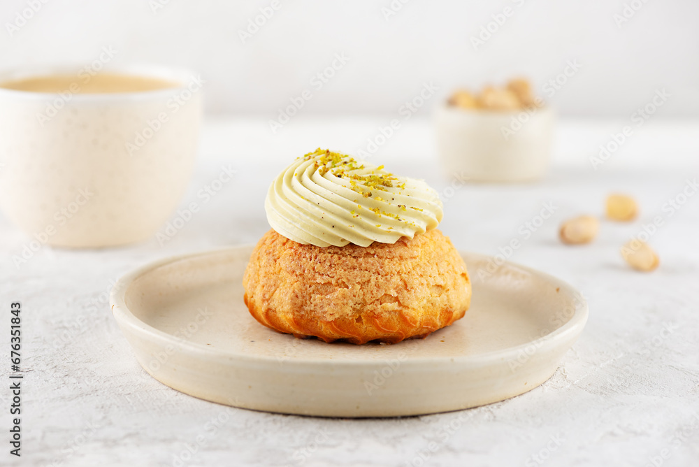 Sweet shu cake with pistachio, cream and a cup of coffee. Sweet shu cake with pistachio, cream and a cup of coffee.