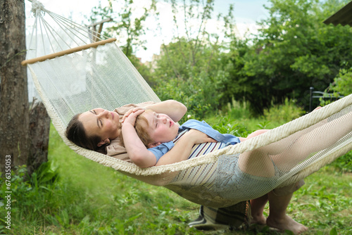 Natural Harmony: A balanced moment where mother and son align their energies, exchanging love and thoughts, swaying in a hammock