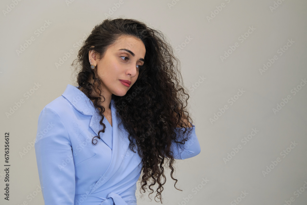 With a serene expression, she tweaks her cascading curls, covered in gloves. Curly hair requires specific maintenance to retain its bounce. With a serene expression, she tweaks her cascading curls, covered in gloves. Curly hair requires specific maintenance to retain its bounce.