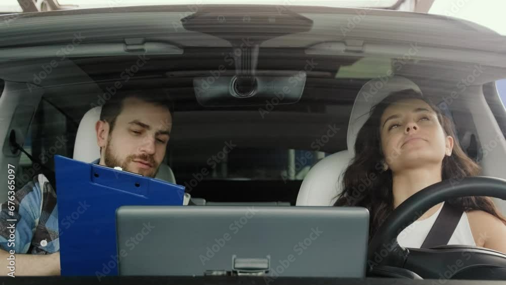 Driving instructor showing test results for lady in the car. Slow motion Driving instructor showing test results for lady in the car. Slow motion