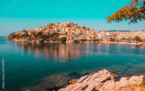 Scenic view of Kavala city in northern Greece with colorful houses, clear Aegean waters, and historic architecture along the coastline