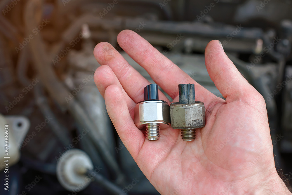 Foto de Knock sensor. Man repair broken car, engine detonation, change
