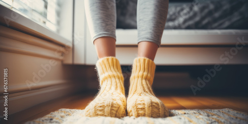 Woman at home in warm wool socks in winter time. concept of keeping warm in winter. photo