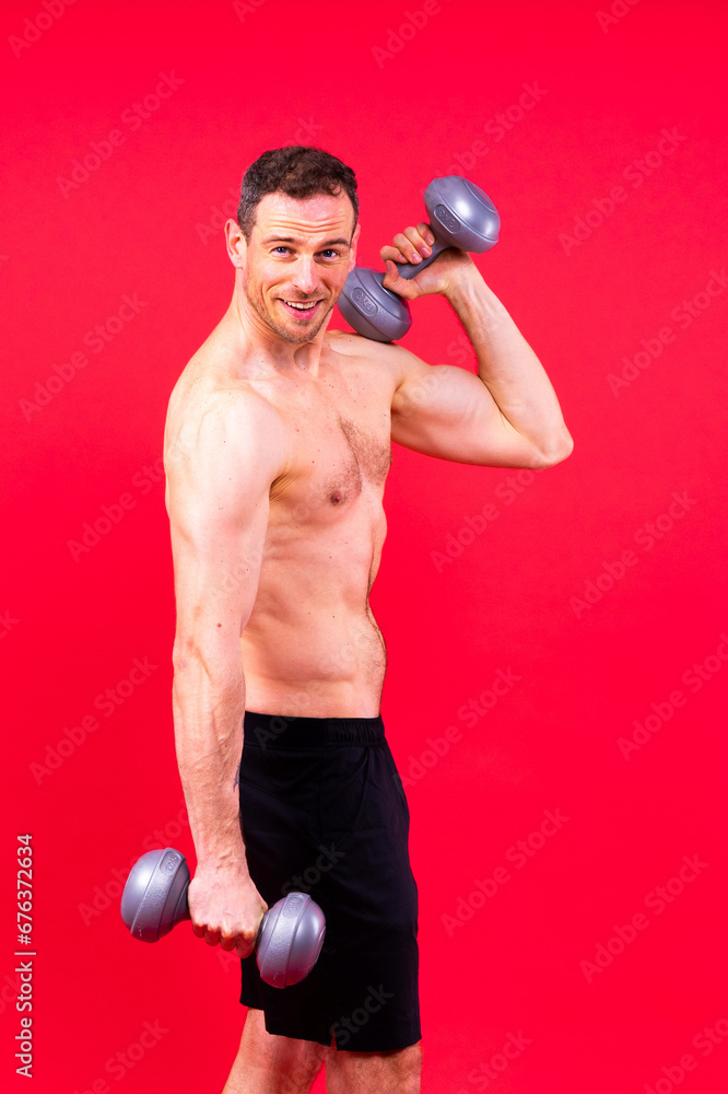 Handsome young fitness sporty strong guy bare-chested muscular sportsman on studio background Handsome young fitness sporty strong guy bare-chested muscular sportsman on studio background