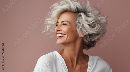 Confident elderly senior model with grey hair,  mature happy smiling female lady in colorful close-up portrait photo