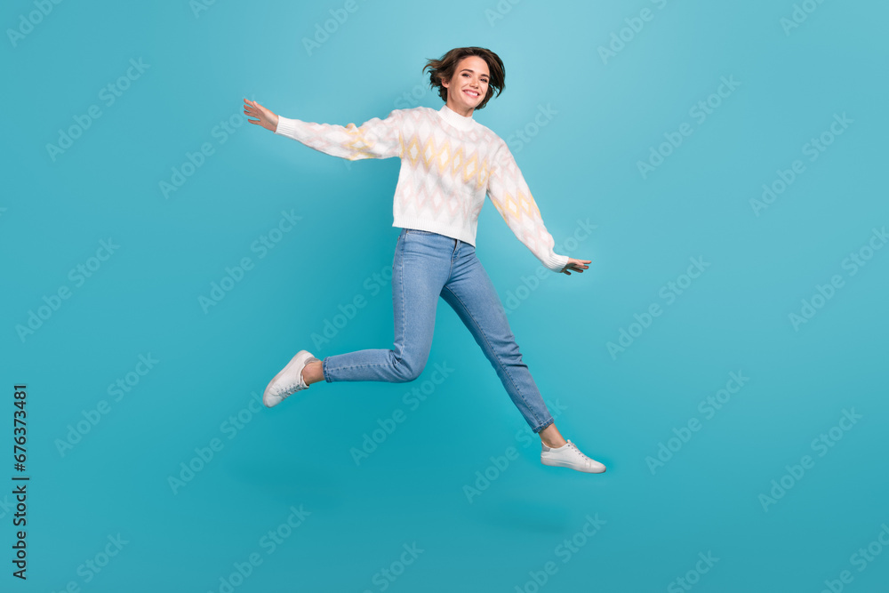 Full body size cadre of jumper crazy woman lightness freedom wear trendy pullover jeans have fun isolated on blue color background