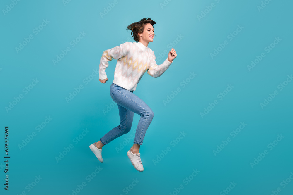 Full body length photo of running person attractive young lady flying jump trampoline workaholic isolated over blue color background