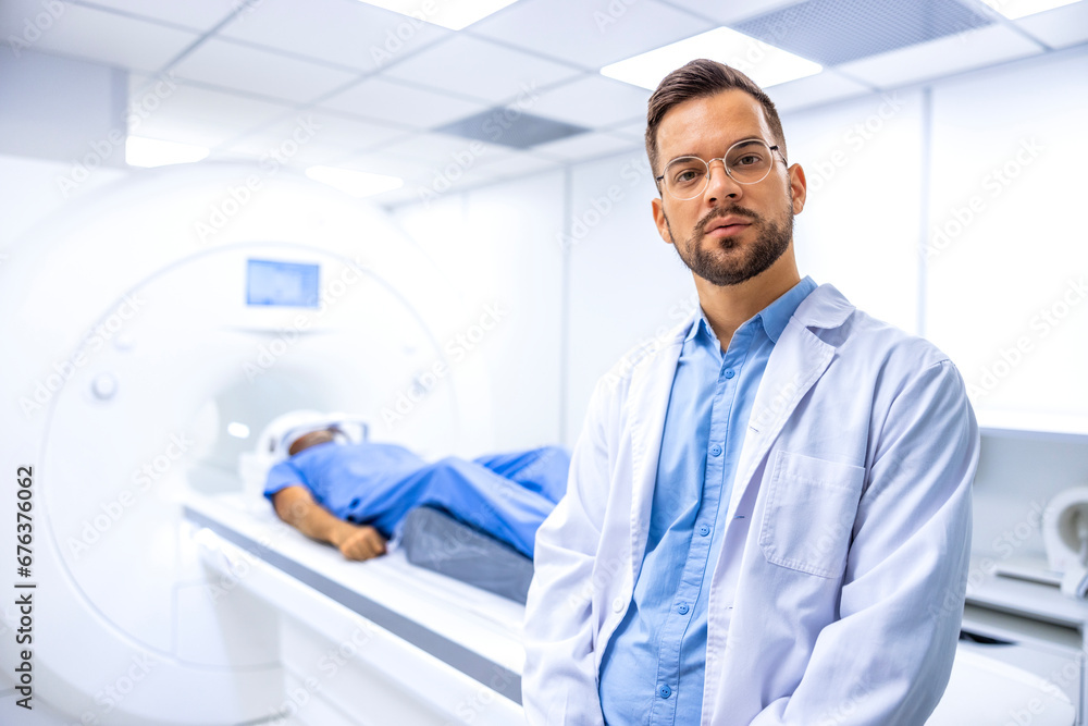 Portrait of serious doctor radiologist standing inside hospital MRI diagnostic center. Patient preparing for full body examination.