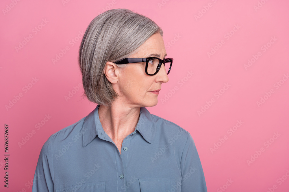 Profile side photo of successful lovely lady realtor broker watching empty space offer adv isolated on pink color background