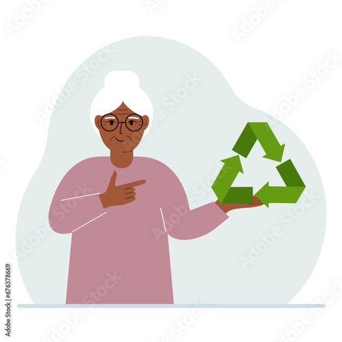 A old woman is holding a green recycle, recycling or ecology sign in his hands.