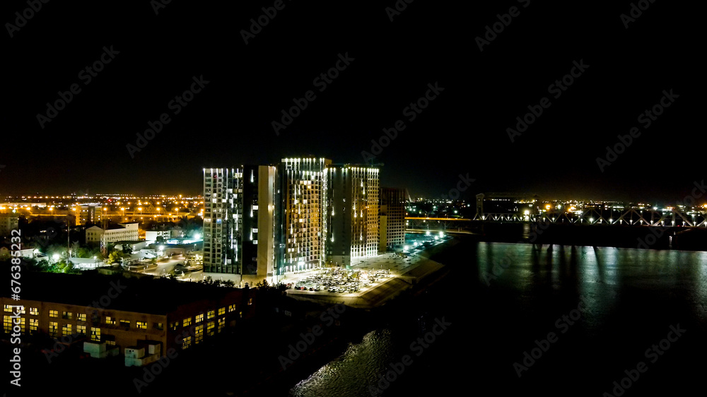 Astrakhan, Russia. A new residential complex on the banks of the Volga River. Night city lights, Aerial View