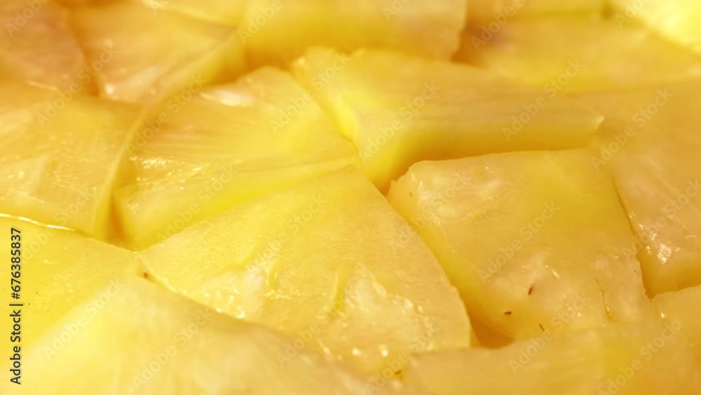 Bright sweet canned yellow pineapple pieces circle rotation close up Bright sweet canned yellow pineapple pieces circle rotation close up