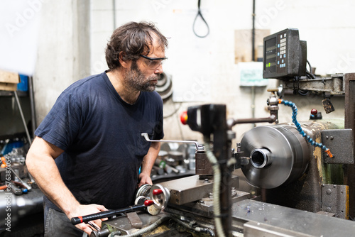 Photography Worker using lathe in a factory