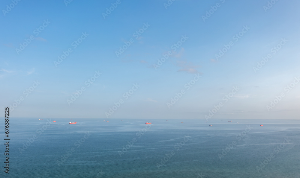 A group of cargo ship vessels in the Baltic sea waiting to enter the port of Skagen, Denmark. Aerial landscape.