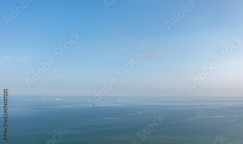 Obraz na płótnie A group of cargo ship vessels in the Baltic sea waiting to enter the port of Skagen, Denmark. Aerial landscape. w salonie