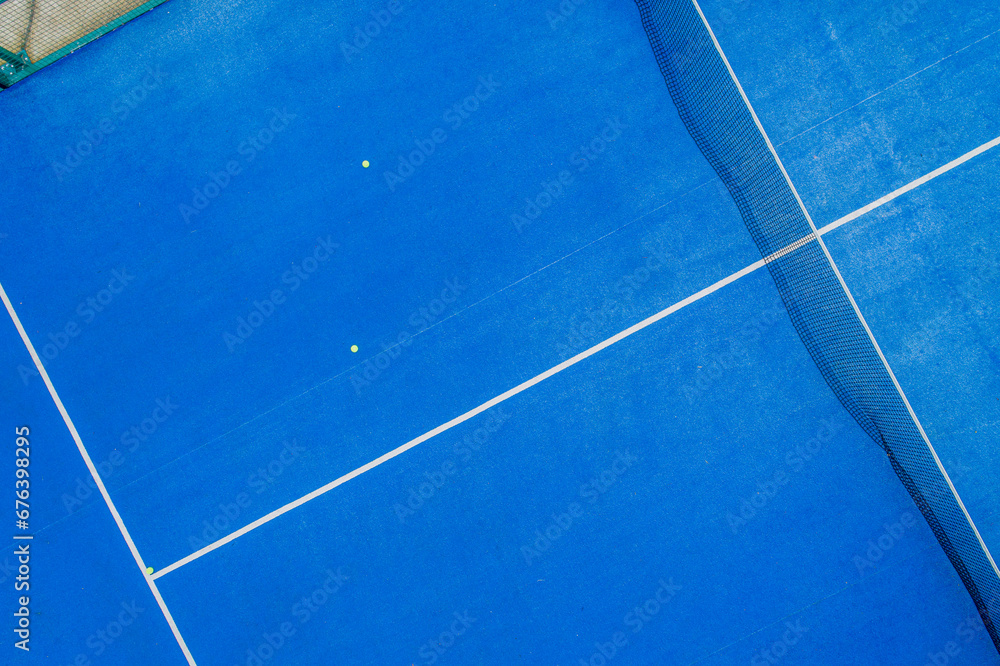 zenithal aerial view with a drone of a blue paddle tennis court