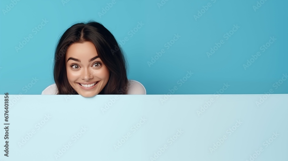 Woman peeking behind a wall or blank banner, blue theme Woman peeking behind a wall or blank banner, blue theme