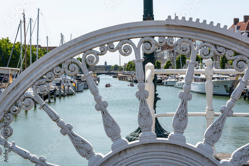 Through the bars of the mechanism of the historic drawbridge, the Spijkerbrug, you can look out onto the Binnenhaven or Middelburg photo