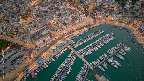 Aerial view of seafront and old town Bisceglie in Puglia with drone on sunset.