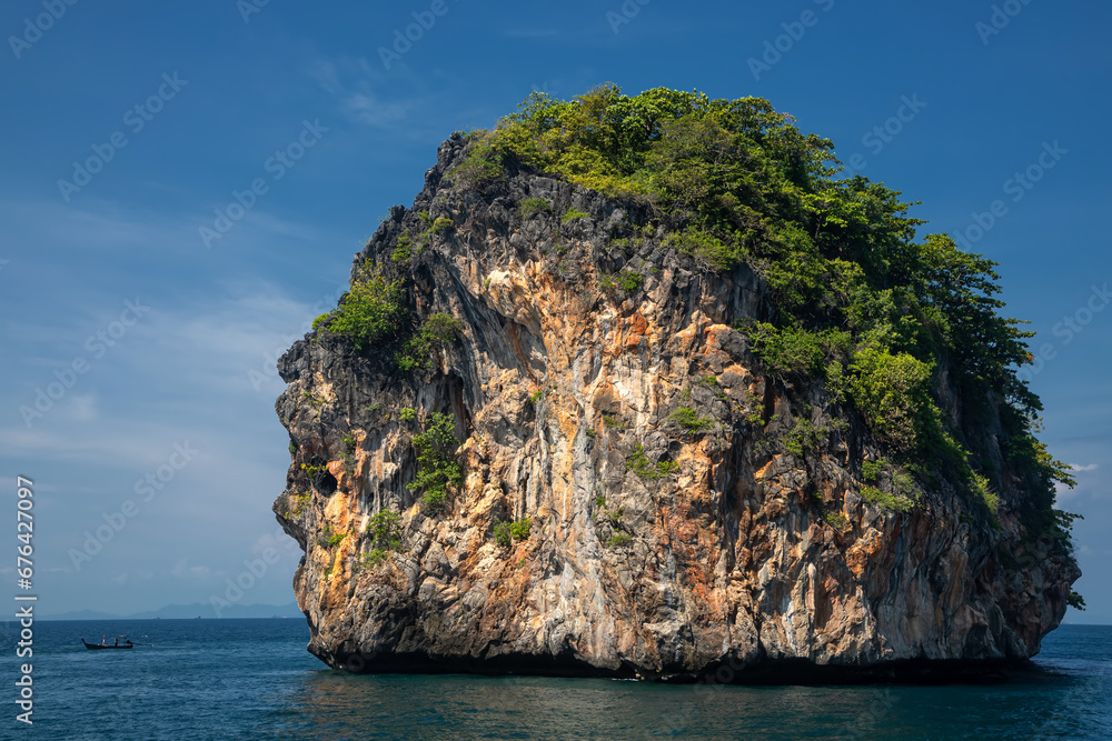 Small island with trees in the water. Beautiful sea in Thailand. Sandy beach. Sunny morning.	
